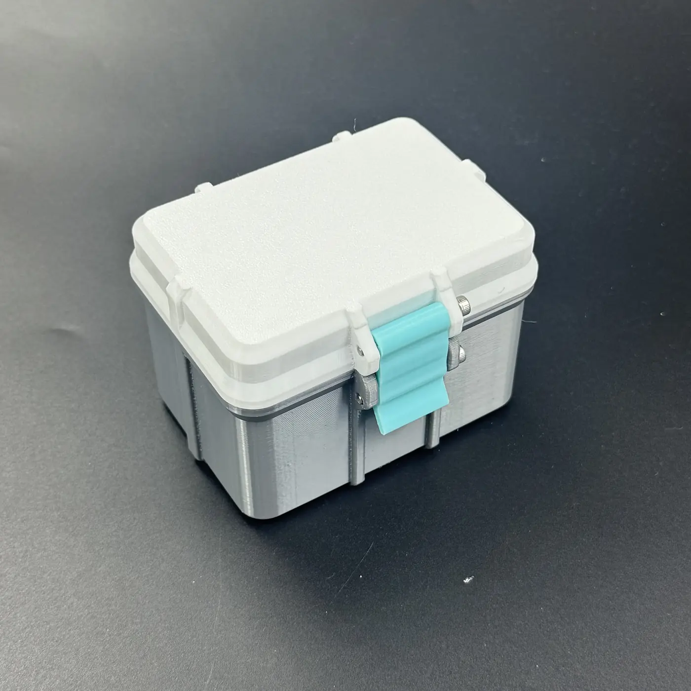 multi-size vial storage box in grey PETG with white lid and teal strap, closed
