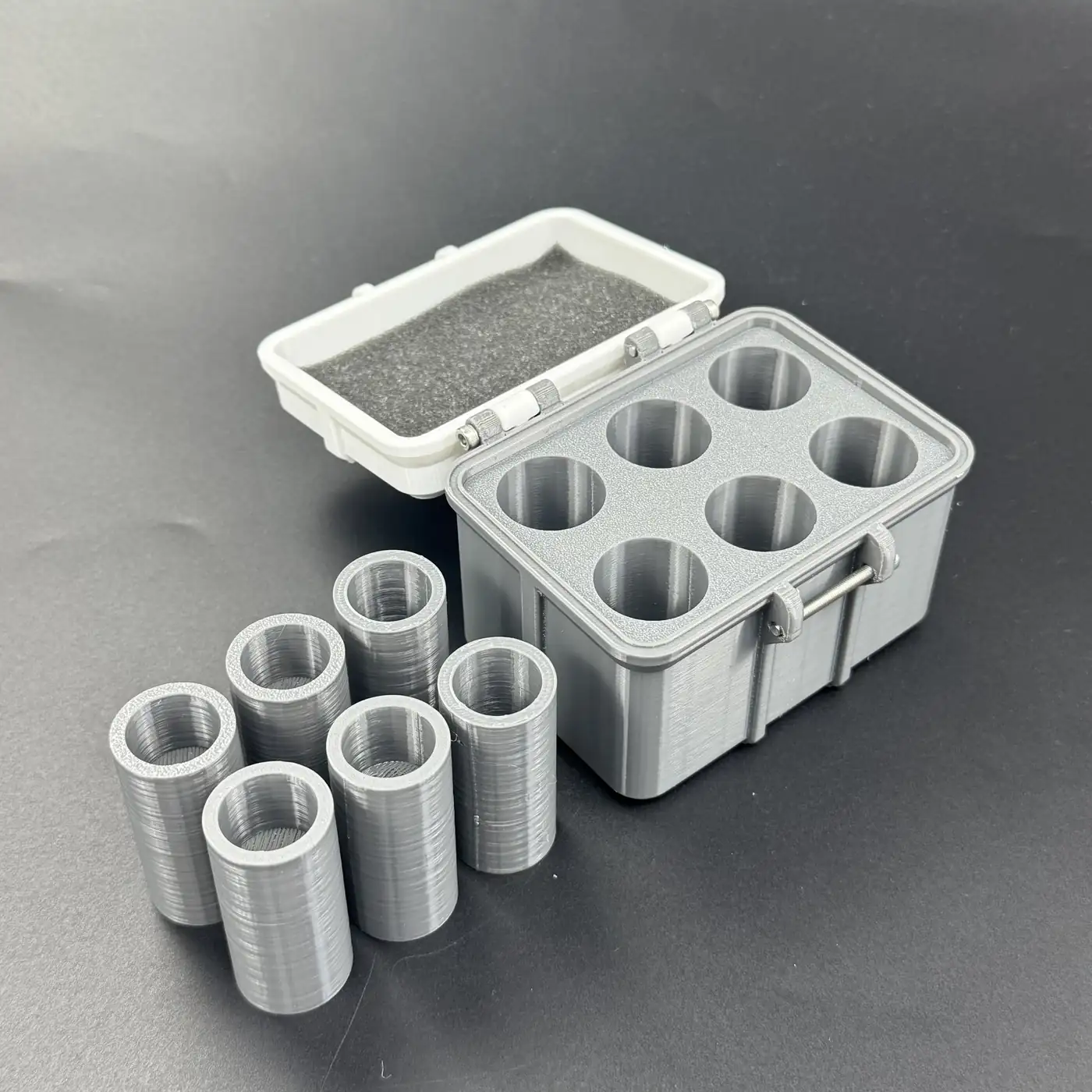 multi-size vial storage box with all six cavities removed and lined up beside the open insert