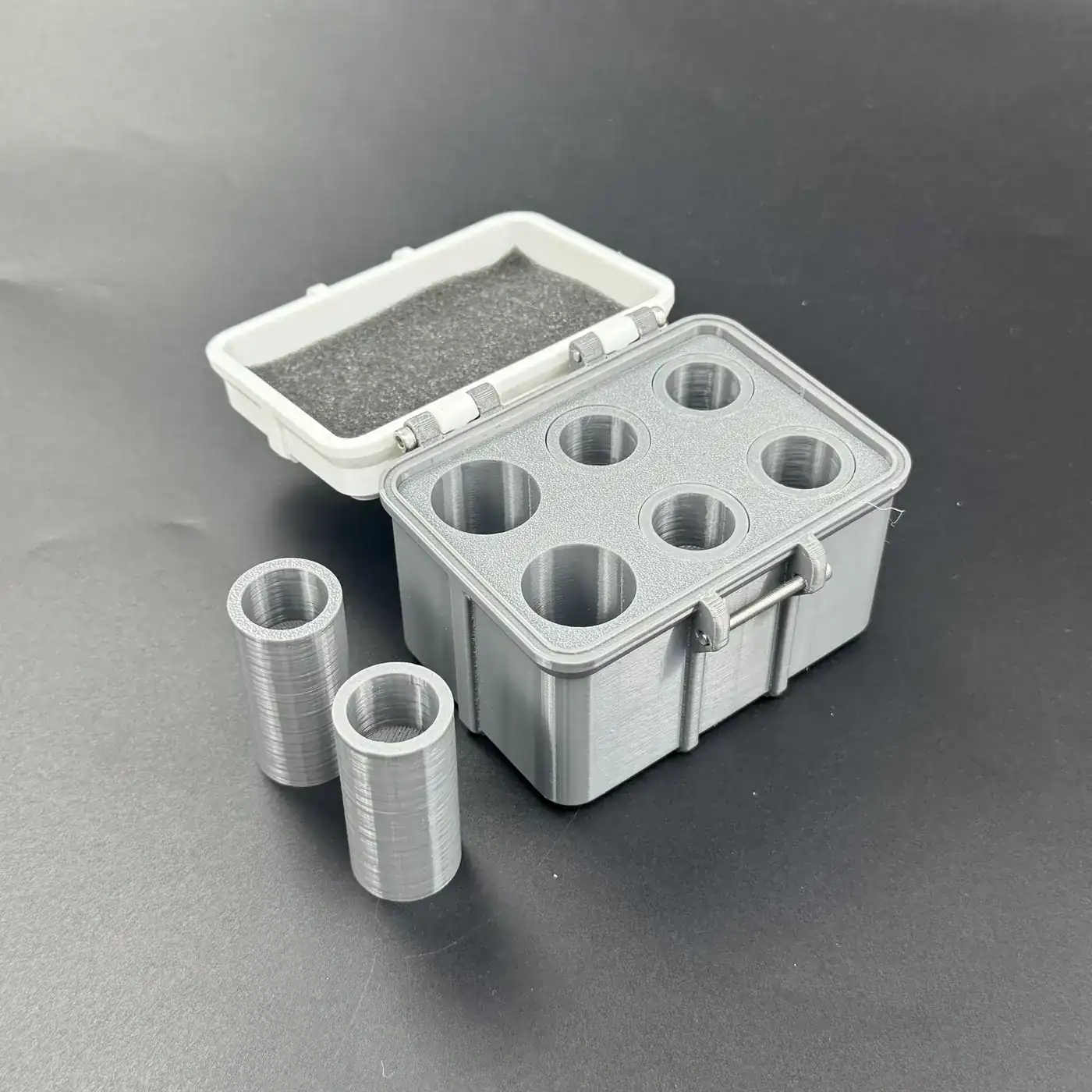 two PETG cavities of different depths beside the open multi-size vial storage box