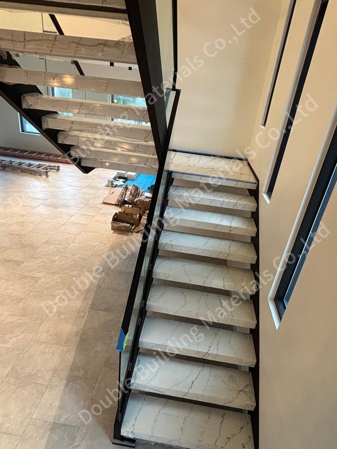 Overhead view of stone side stringer staircase and base-channel glass