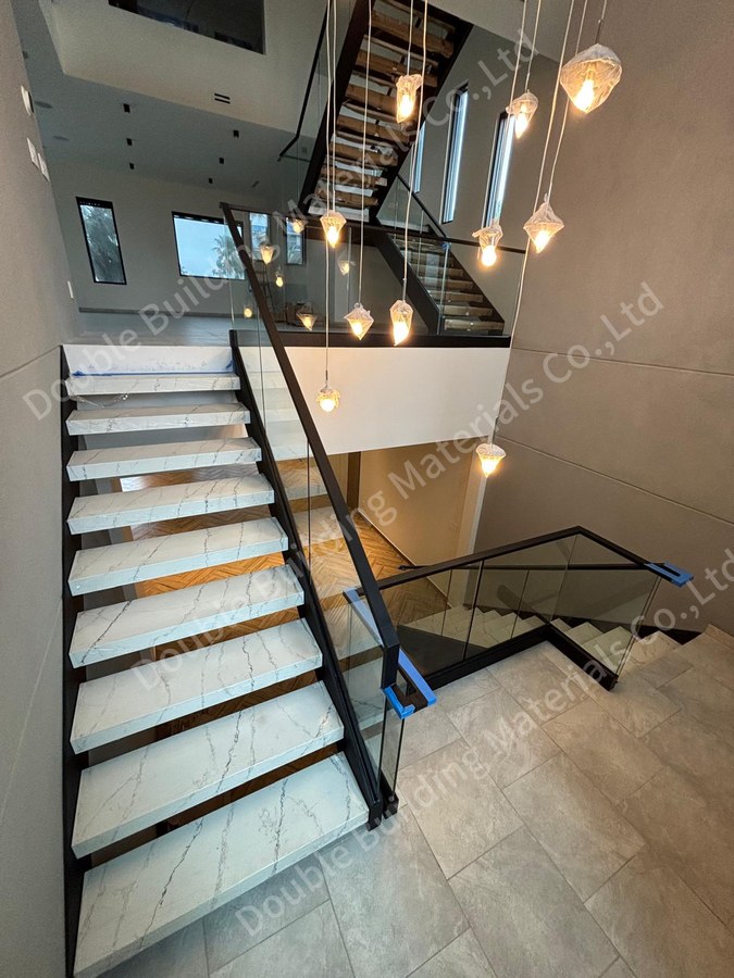 Stone side panel staircase during install with protective wrap on panels