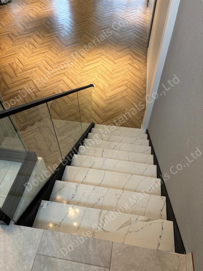 Multi-flight Texas stone stair with dark side panels and glass guard