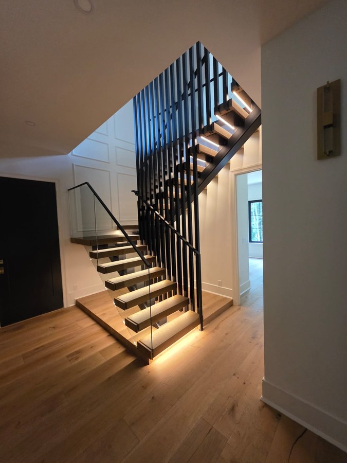 Side view of black square tube mono-stringer with open wood treads in Charleston